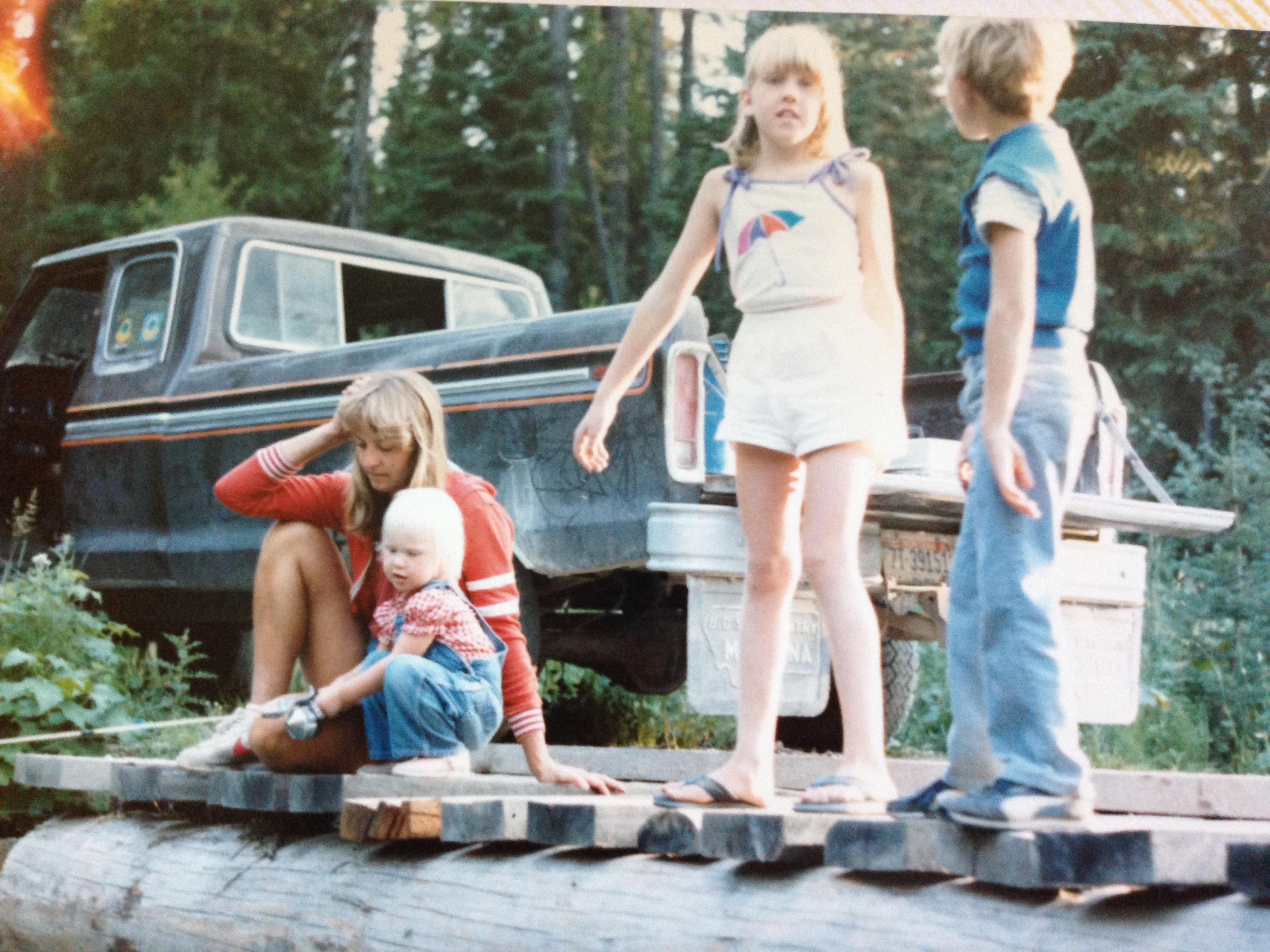 My mother and I fishing off the bridge (left) while our knobby kneed big sister works at spotting fish.